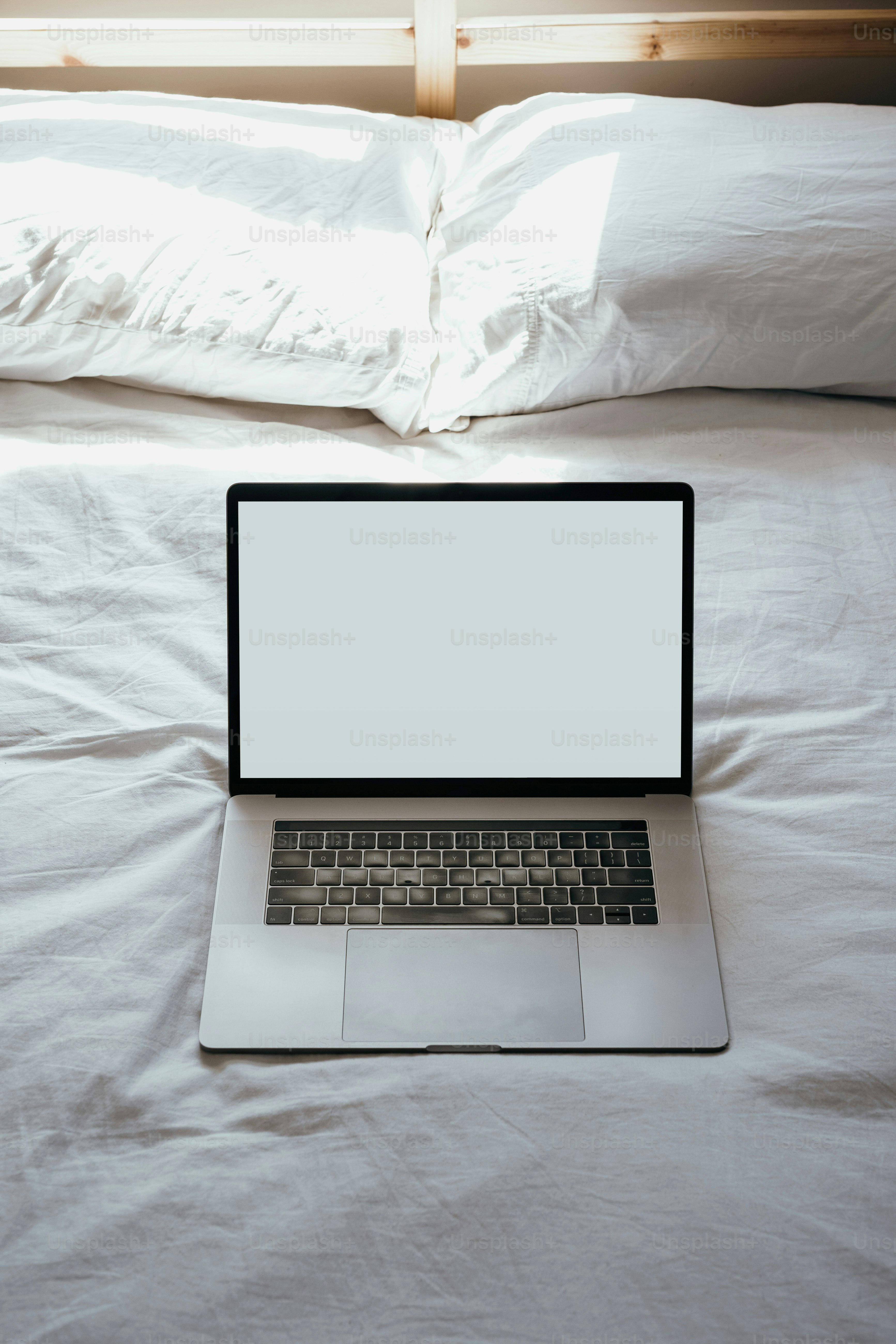 Blank laptop resting on a bed 2/4 (IG: @clay.banks)